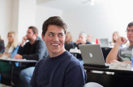 Student sitting in a lecture classroom.